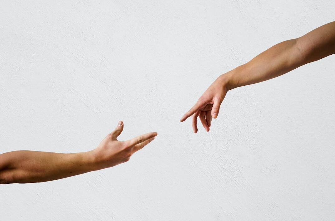 Close-up of two hands in a gentle gesture of connection