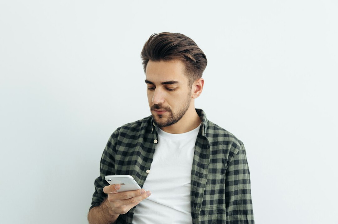 person checking phone anxiously